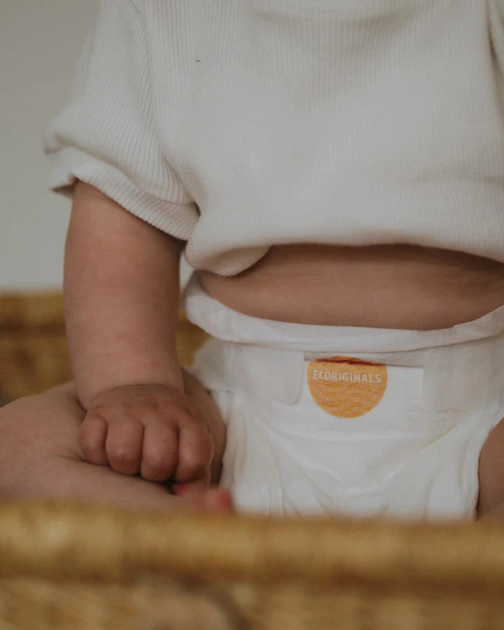 Baby in basket with Ecoriginals Biodegradable Nappies